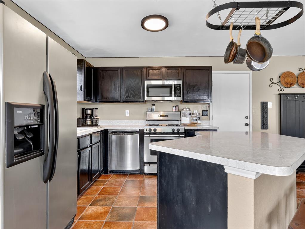 2052 Diamond Ridge Drive Carrollton, TX 75010 - Photo 33 of 40 a kitchen with stainless steel appliances granite countertop a refrigerator and a stove top oven