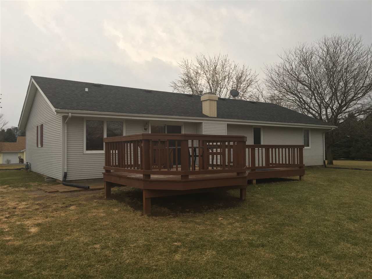 6282 Upper Ridge Way Roscoe, IL 61073 - Photo 23 of 23 a view of a house with a wooden deck and a yard