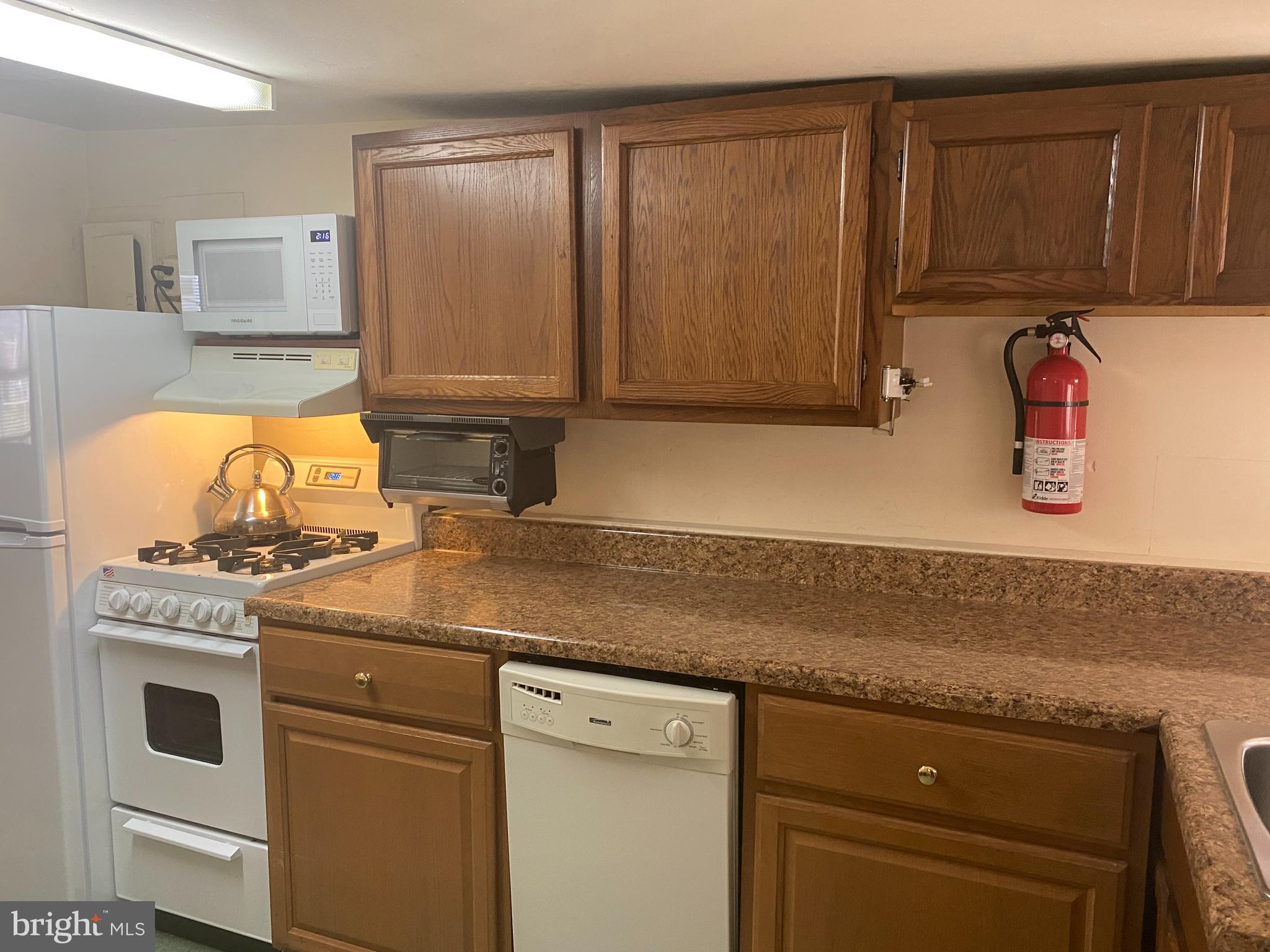 220 Crystal Drive Williamstown, NJ 08094 - Photo 8 of 16 a kitchen with stainless steel appliances granite countertop a sink stove and cabinets