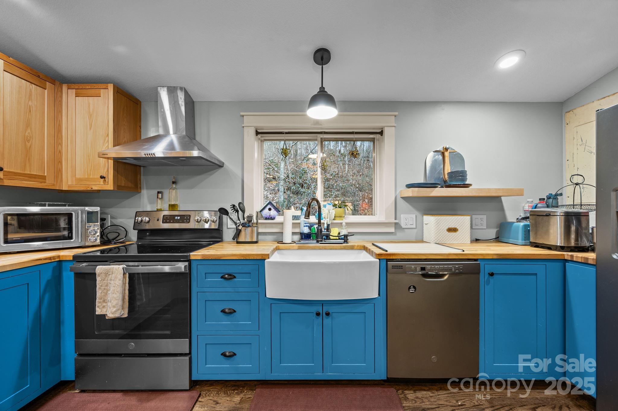 2144 Wilson Road Asheville, NC 28806 - Photo 13 of 27 a kitchen with granite countertop a sink stainless steel appliances and cabinets