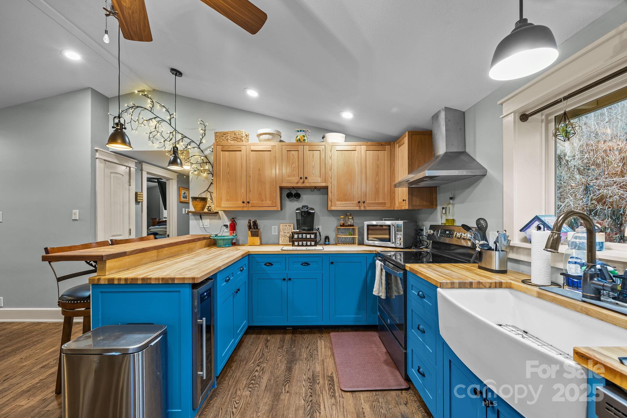 2144 Wilson Road Asheville, NC 28806 - Photo 15 of 27 a kitchen with stainless steel appliances granite countertop wooden cabinets a sink dishwasher a stove and a refrigerator