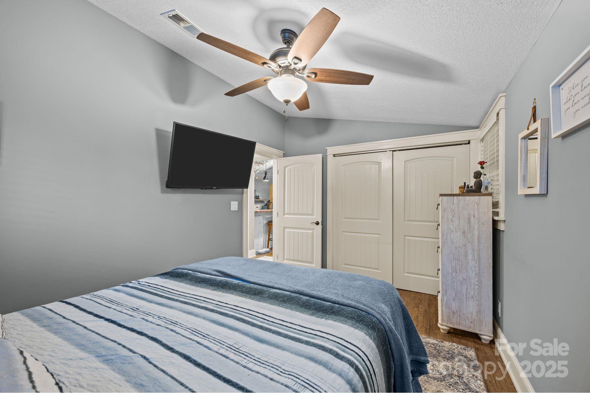 2144 Wilson Road Asheville, NC 28806 - Photo 17 of 27 a bedroom with a bed and a flat screen tv