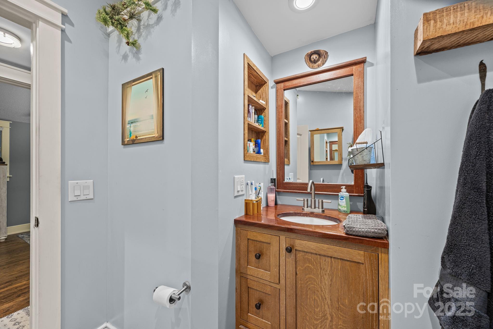 2144 Wilson Road Asheville, NC 28806 - Photo 21 of 27 a bathroom with mirror and vanity