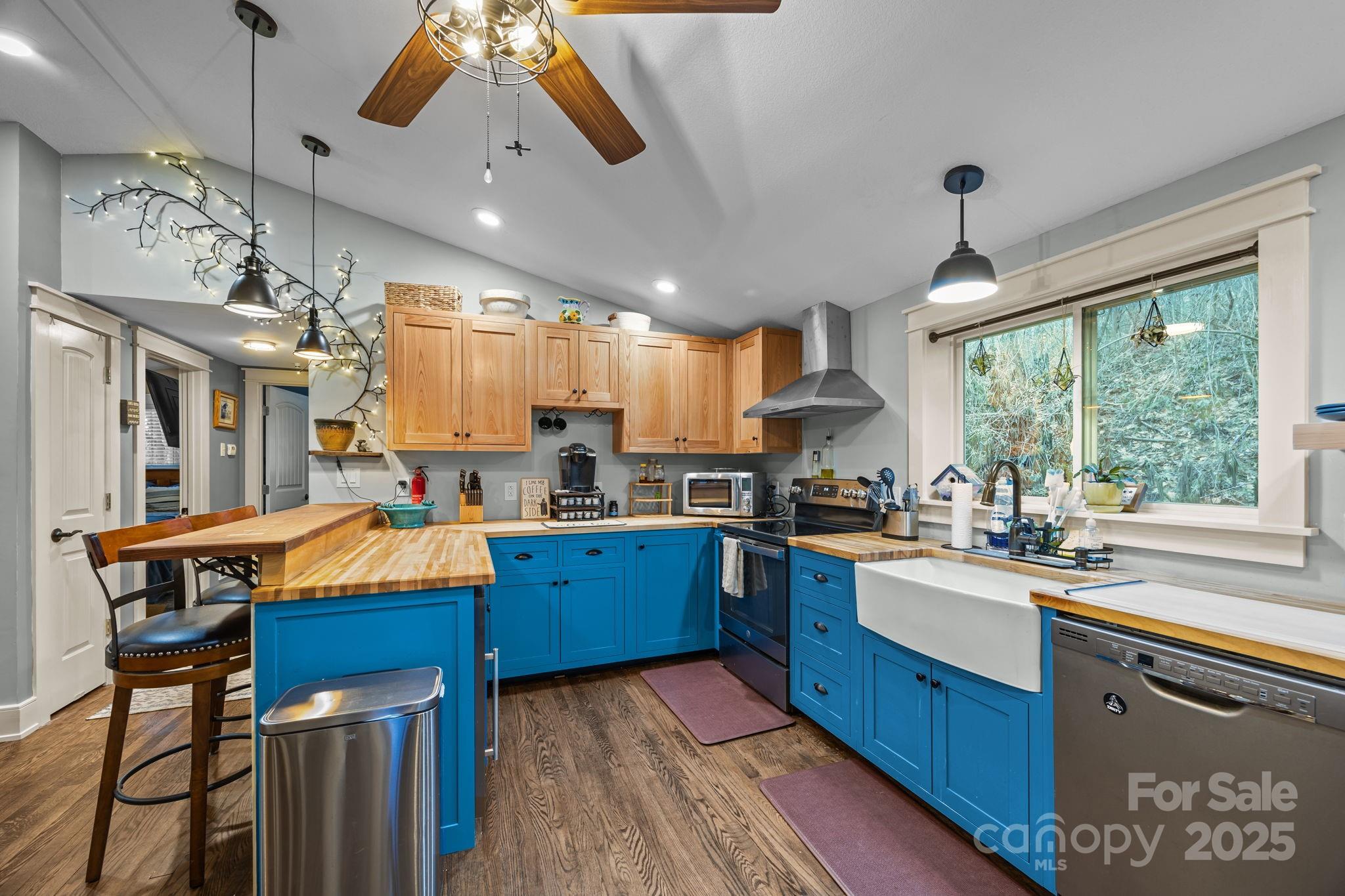 2144 Wilson Road Asheville, NC 28806 - Photo 3 of 27 a kitchen with stainless steel appliances kitchen island granite countertop a stove refrigerator and cabinets