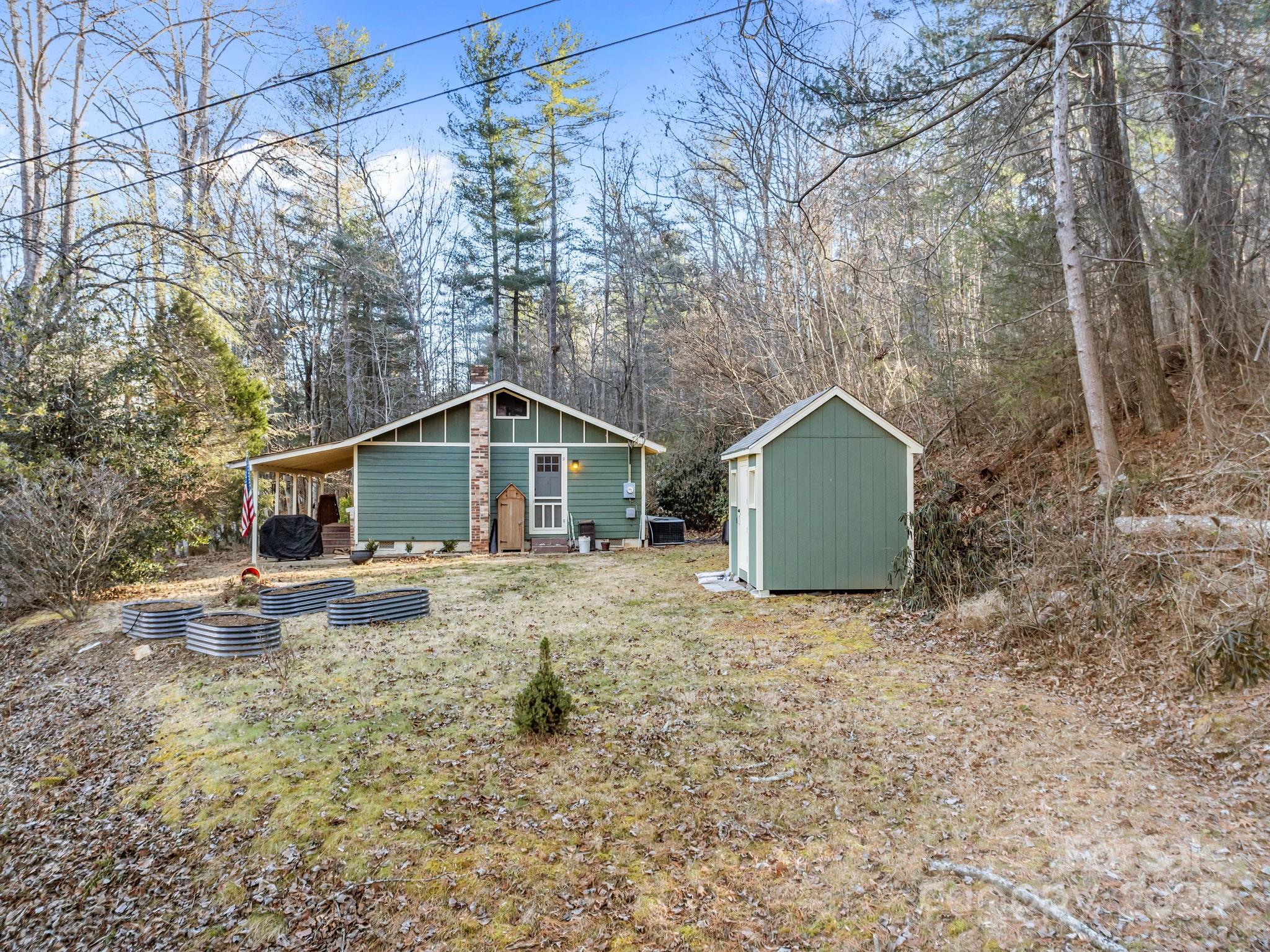 2144 Wilson Road Asheville, NC 28806 - Photo 5 of 27 a backyard of a house with wooden fence and large trees