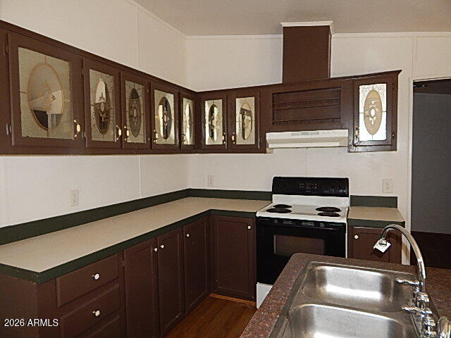 24231 West Patton Road Wittmann, AZ 85361 - Photo 3 of 12 a kitchen with a stove and a microwave