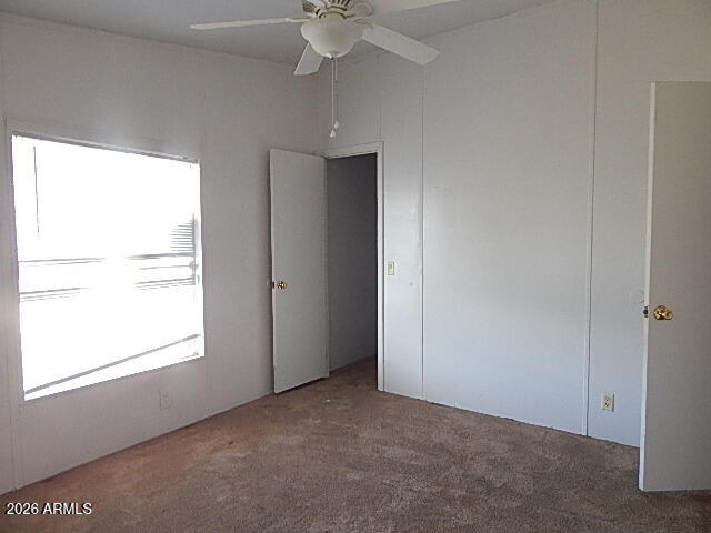 24231 West Patton Road Wittmann, AZ 85361 - Photo 6 of 12 a view of an empty room with a window