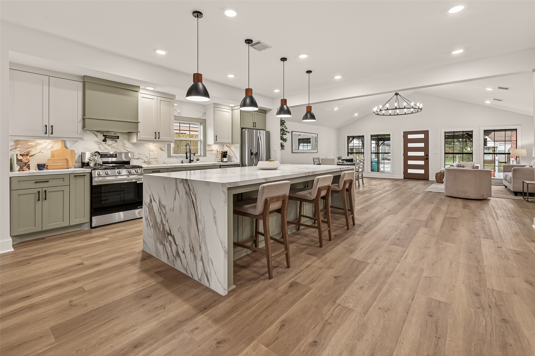 a kitchen with stainless steel appliances granite countertop a lot of cabinets and wooden floor