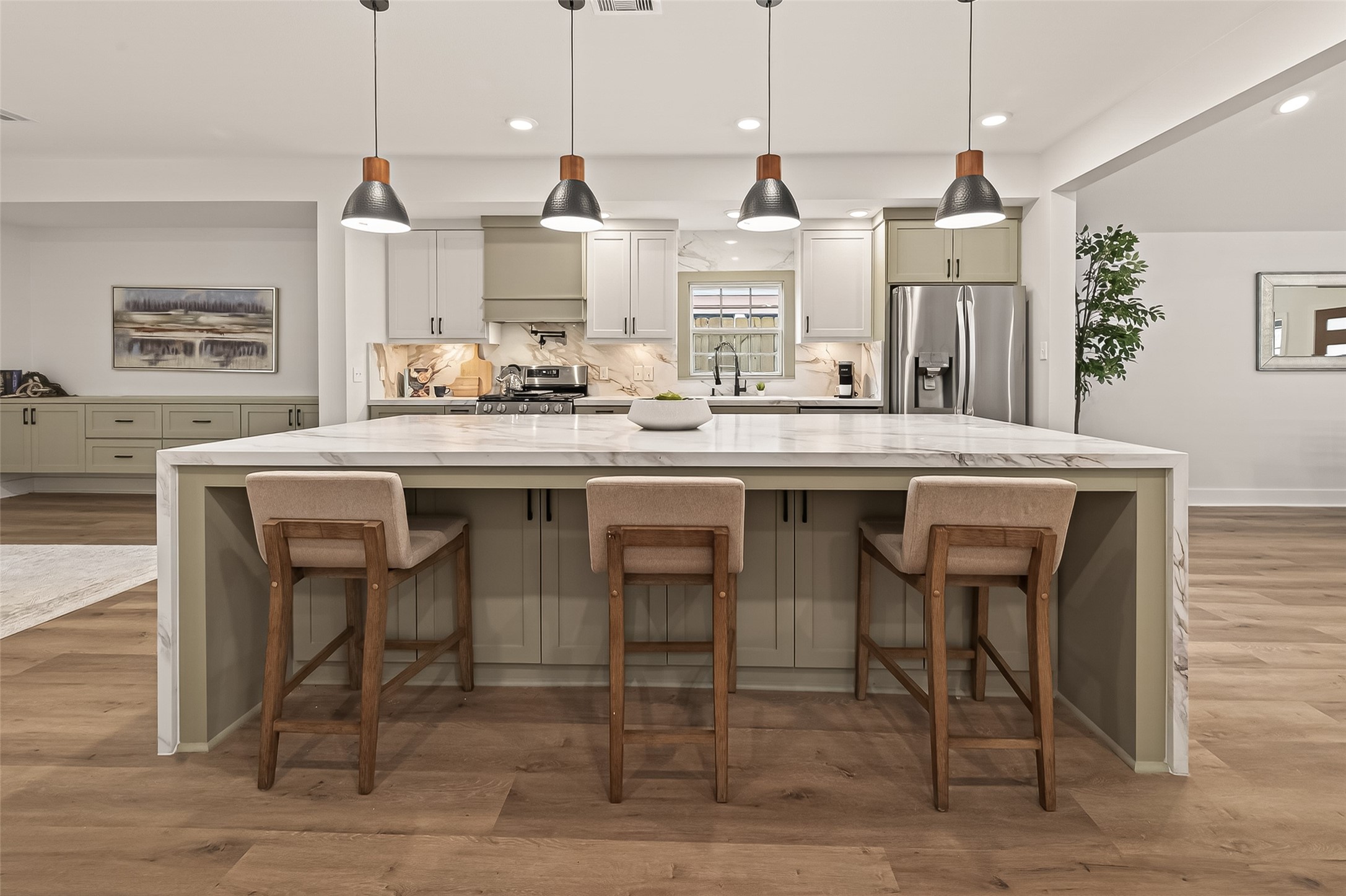 906 Eleanor Street Houston, TX 77009 - Photo 11 of 36 The island is the center of this home! Storage on both sides, waterfall edge, and those pendant lights!