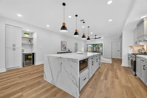 a kitchen with stainless steel appliances granite countertop a stove and a sink
