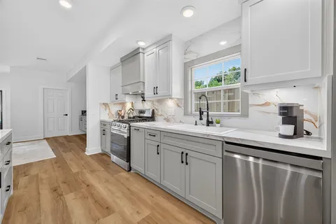 a kitchen with a sink stove and cabinets