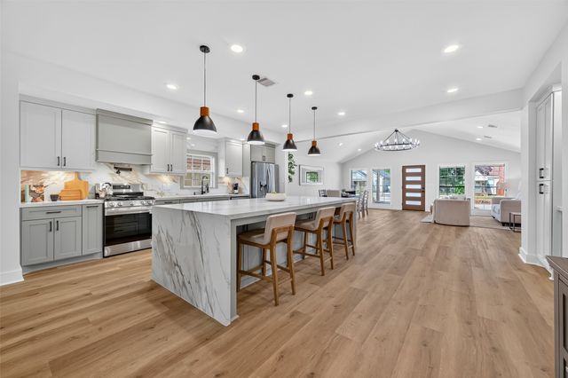 a spacious bathroom with a double vanity sink a mirror and a shower