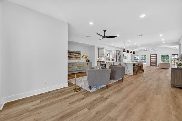 a living room with furniture and kitchen view