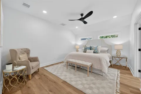 a bedroom with a bed and a lamp on the table