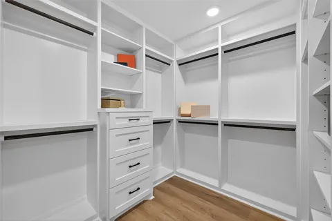 a view of walk in closet with empty racks
