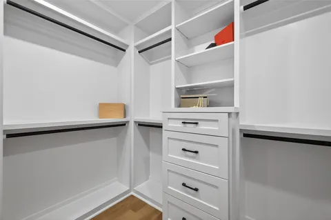 a view of walk in closet with empty racks