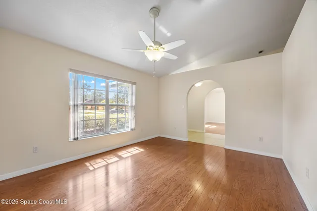 wooden floor in an empty room with a window