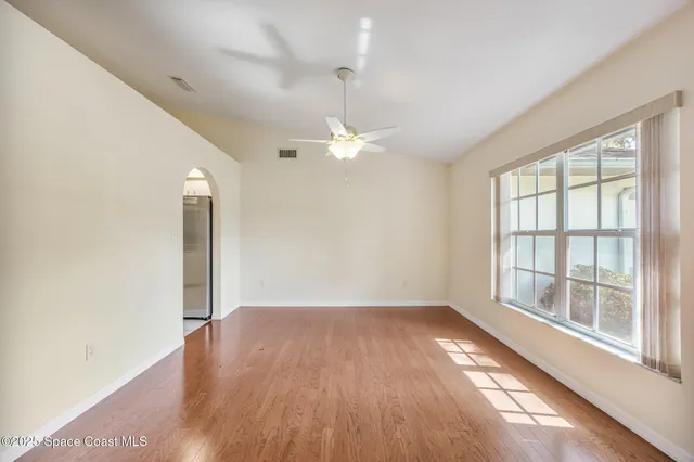 wooden floor in an empty room with a window