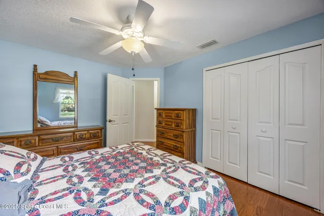 a bedroom with a bed and a dresser