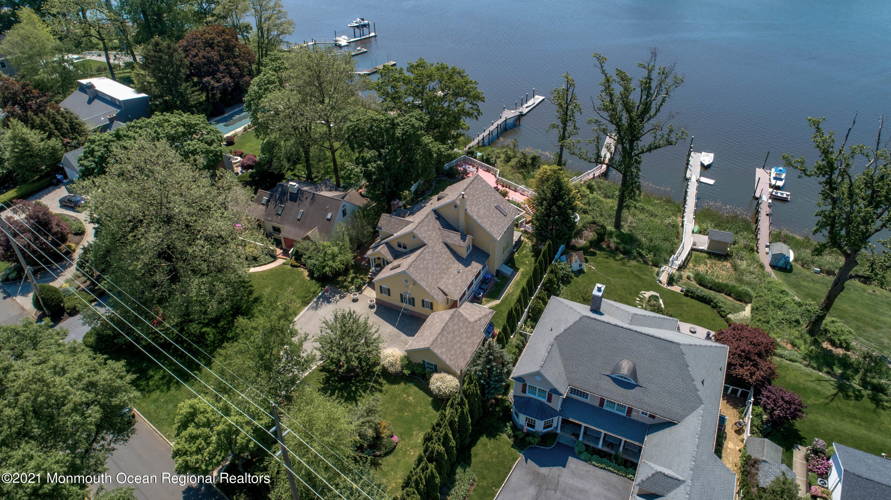 an aerial view of a house with a yard and outdoor seating