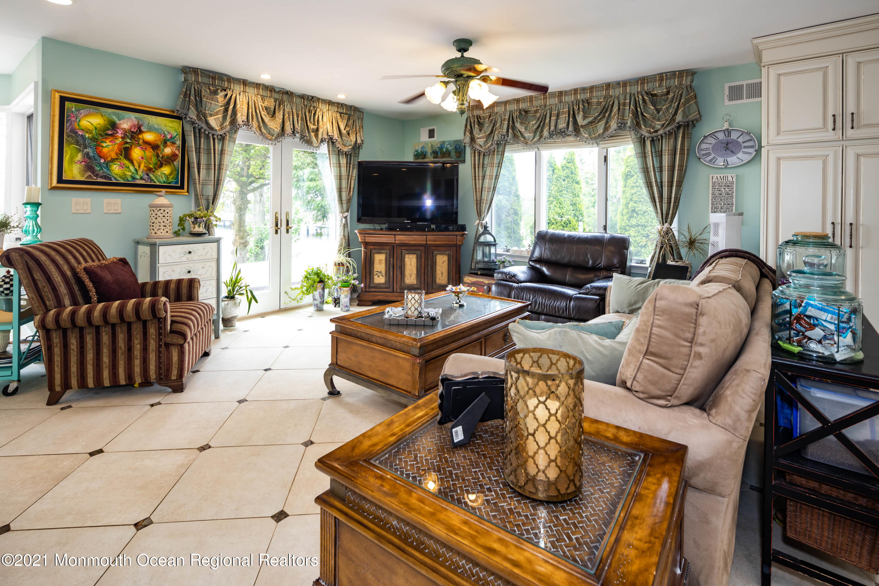 38 Conover Lane Red Bank, NJ 07701 - Photo 22 of 65 a living room with furniture a flat screen tv and a large window