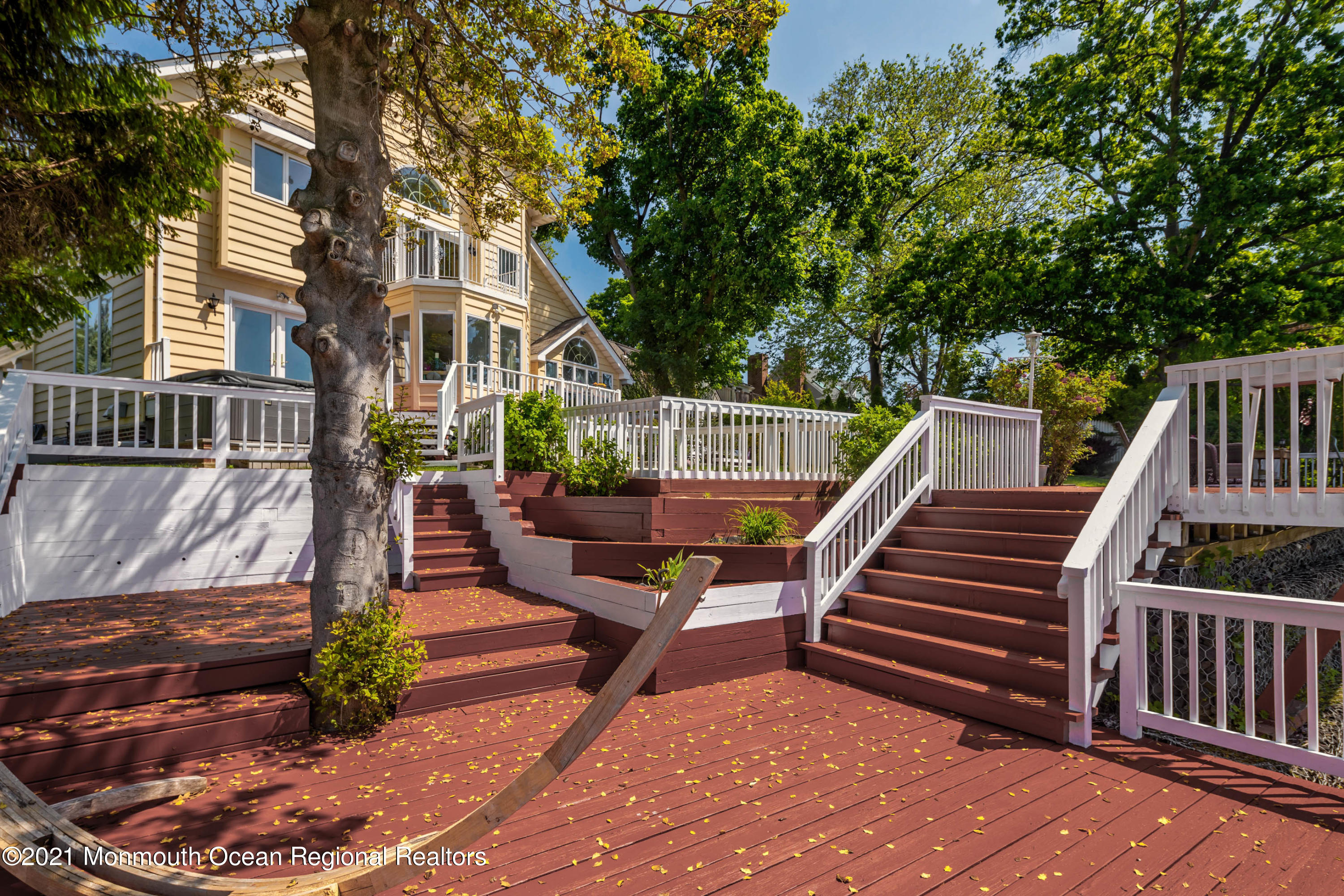 38 Conover Lane Red Bank, NJ 07701 - Photo 54 of 65 a view of a patio with two couches and a table and chairs with wooden floor and fence
