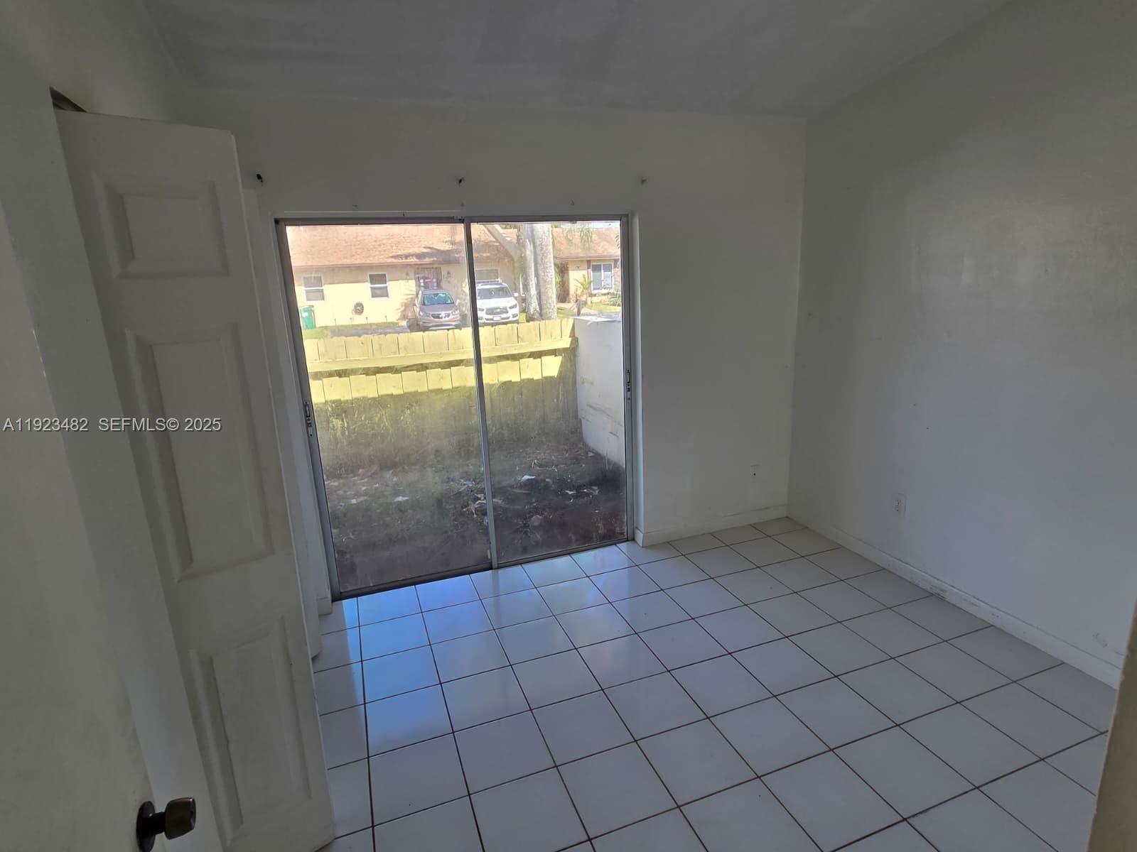 12412 Southwest 112th Terrace Miami, FL 33186 - Photo 11 of 18 a view of an empty room and window