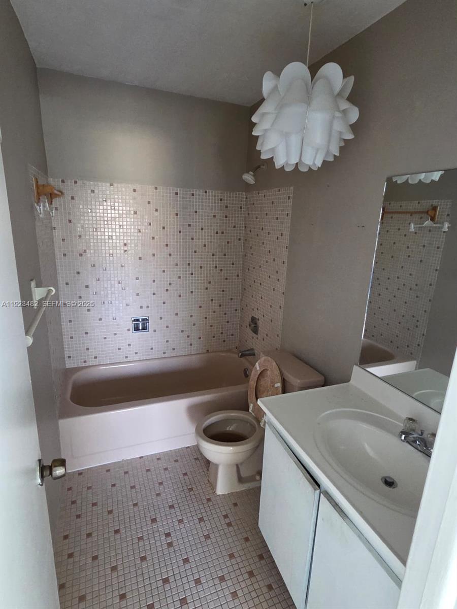12412 Southwest 112th Terrace Miami, FL 33186 - Photo 15 of 18 a bathroom with a sink a toilet and a mirror