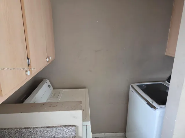 a view of a backyard with wooden fence