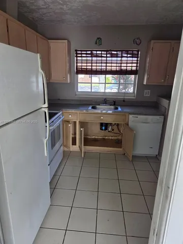 a kitchen with a cabinets and white stainless steel appliances