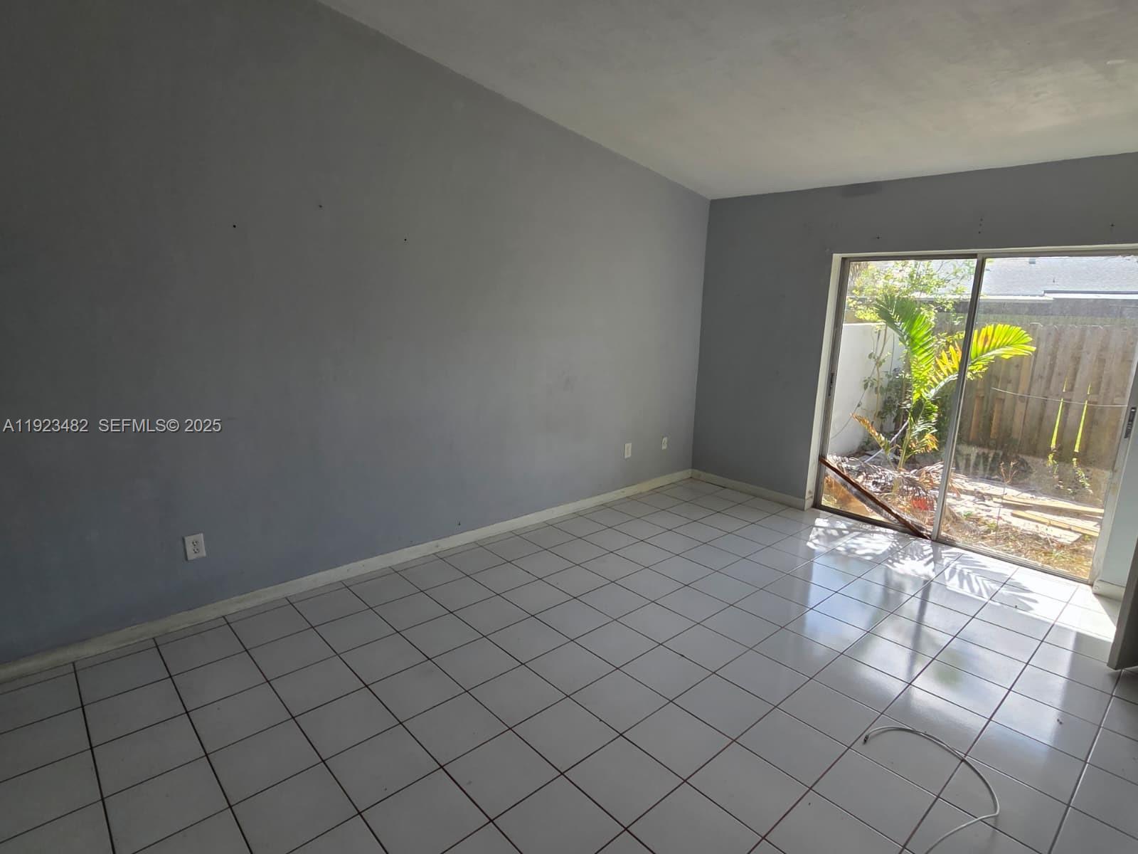 12412 Southwest 112th Terrace Miami, FL 33186 - Photo 6 of 18 a view of an empty room and window