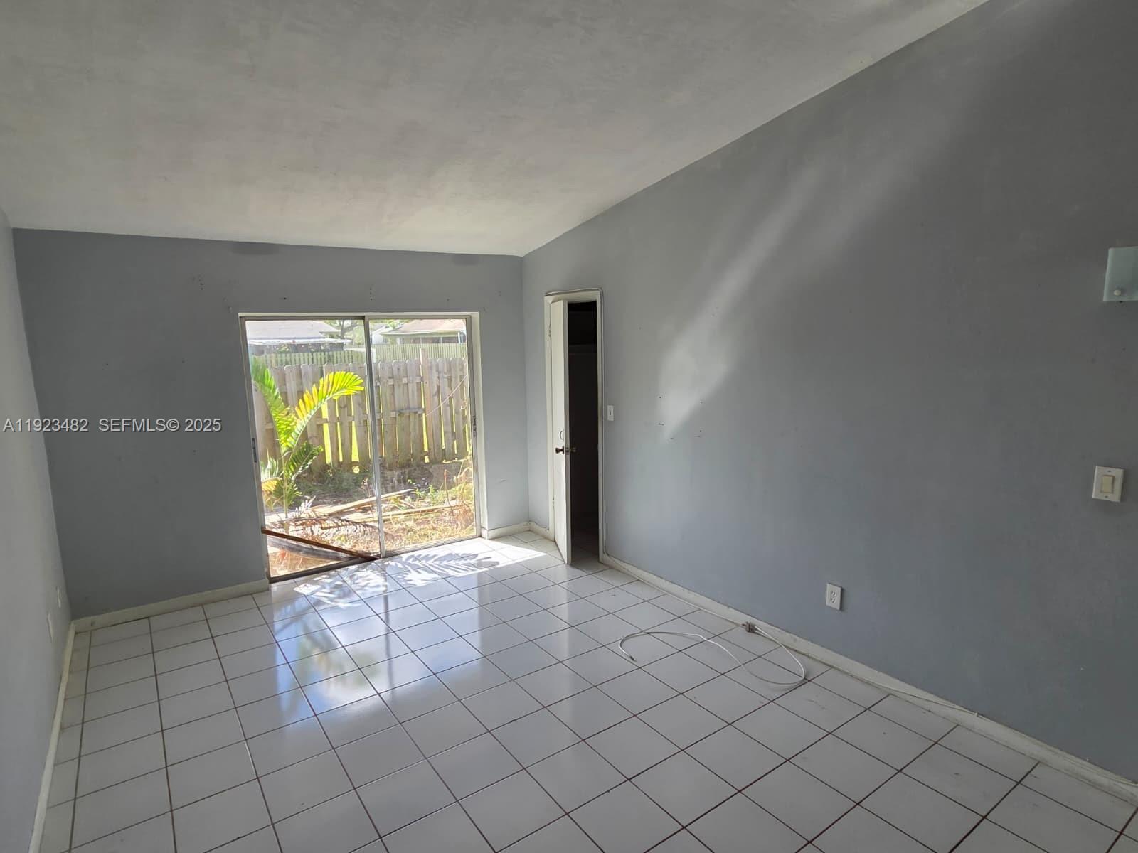 12412 Southwest 112th Terrace Miami, FL 33186 - Photo 7 of 18 a view of an empty room and window