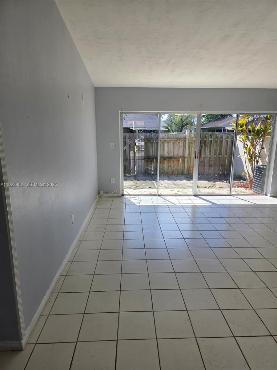 12412 Southwest 112th Terrace Miami, FL 33186 - Photo 9 of 18 a view of empty room with wooden floor and fan