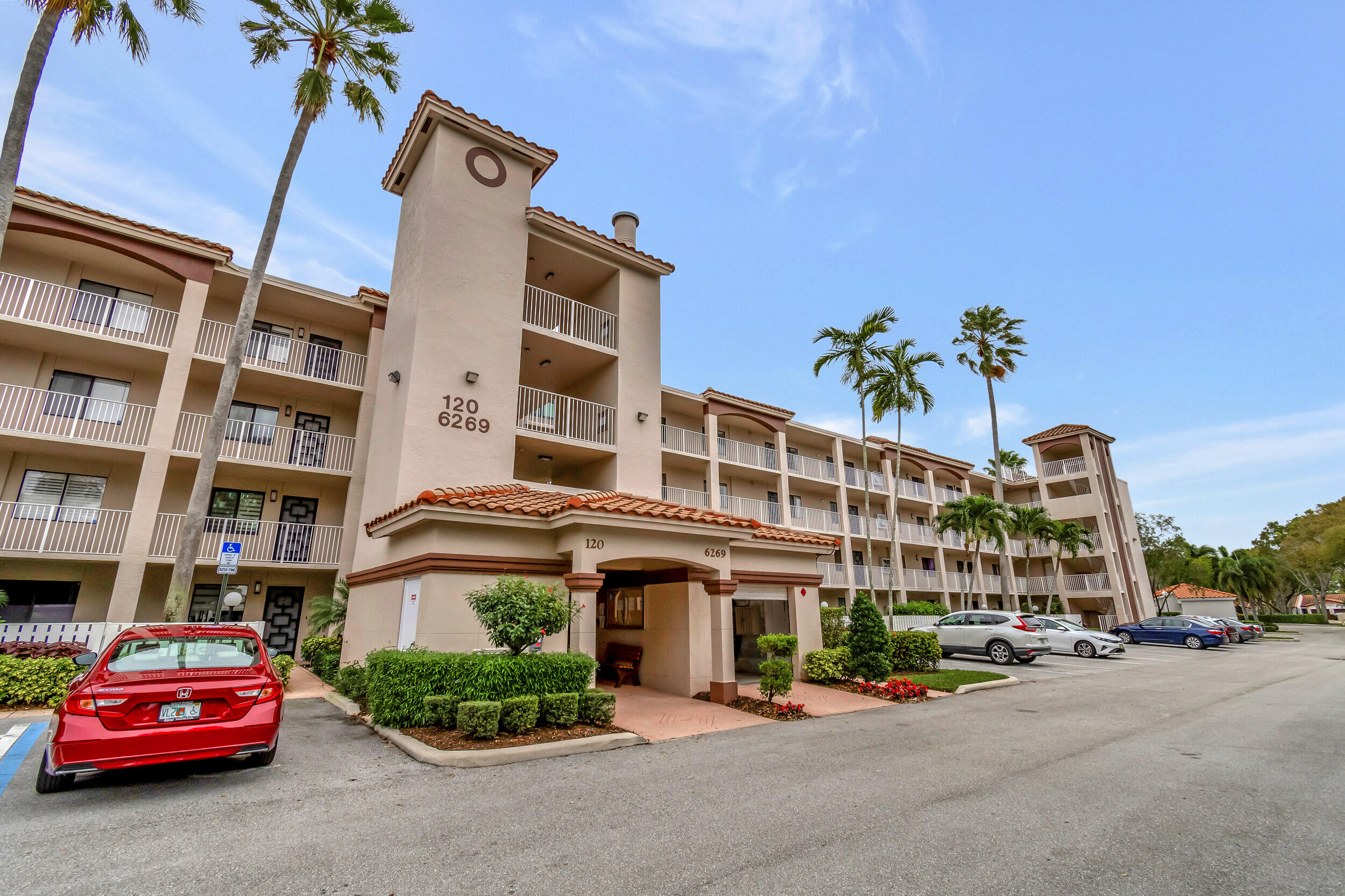 6269 Pointe Regal Circle, Unit 102 Delray Beach, FL 33484 - Photo 1 of 51 a car parked in front of a building