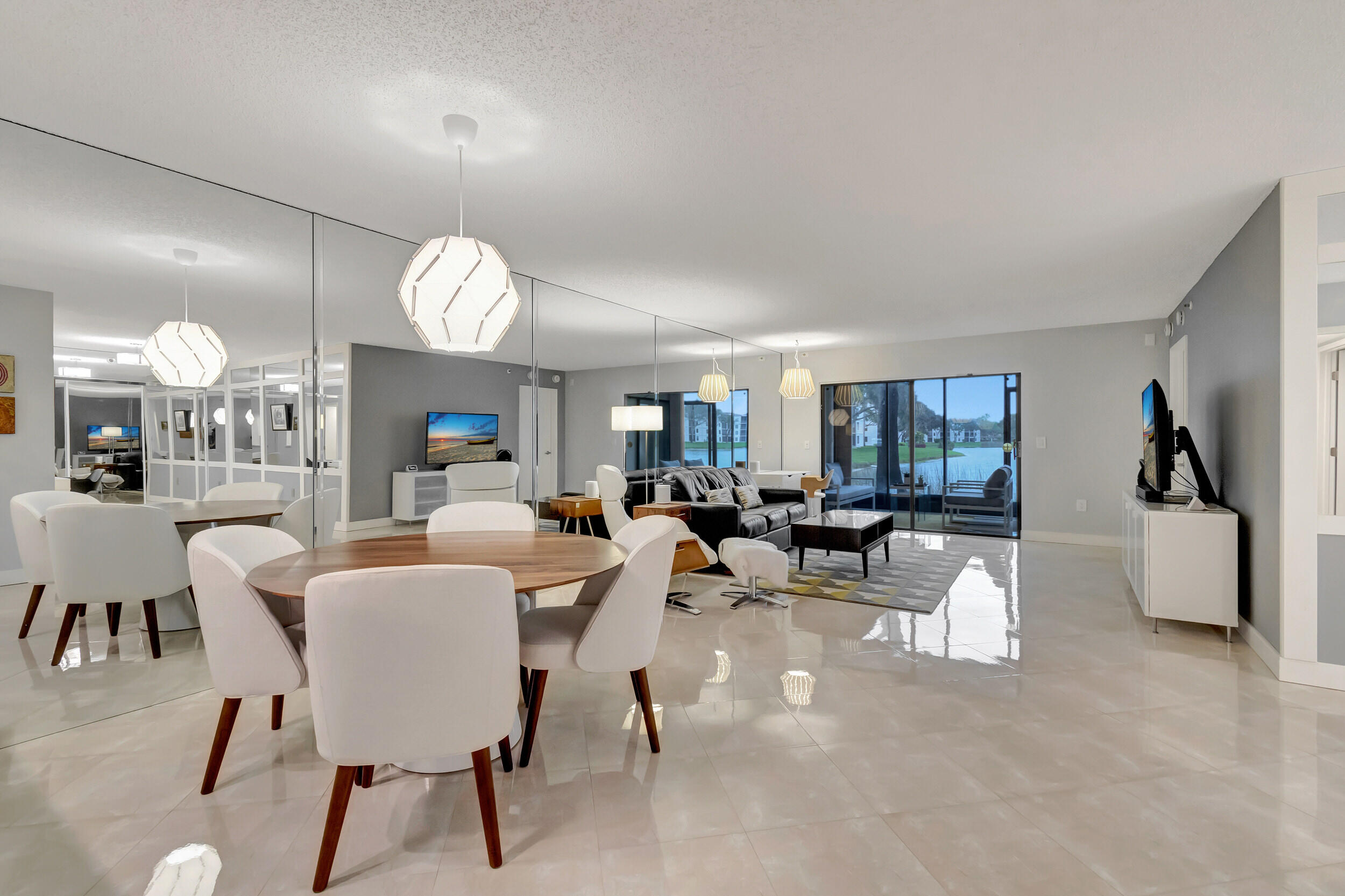6269 Pointe Regal Circle, Unit 102 Delray Beach, FL 33484 - Photo 11 of 51 a view of a dining room with furniture and chandelier