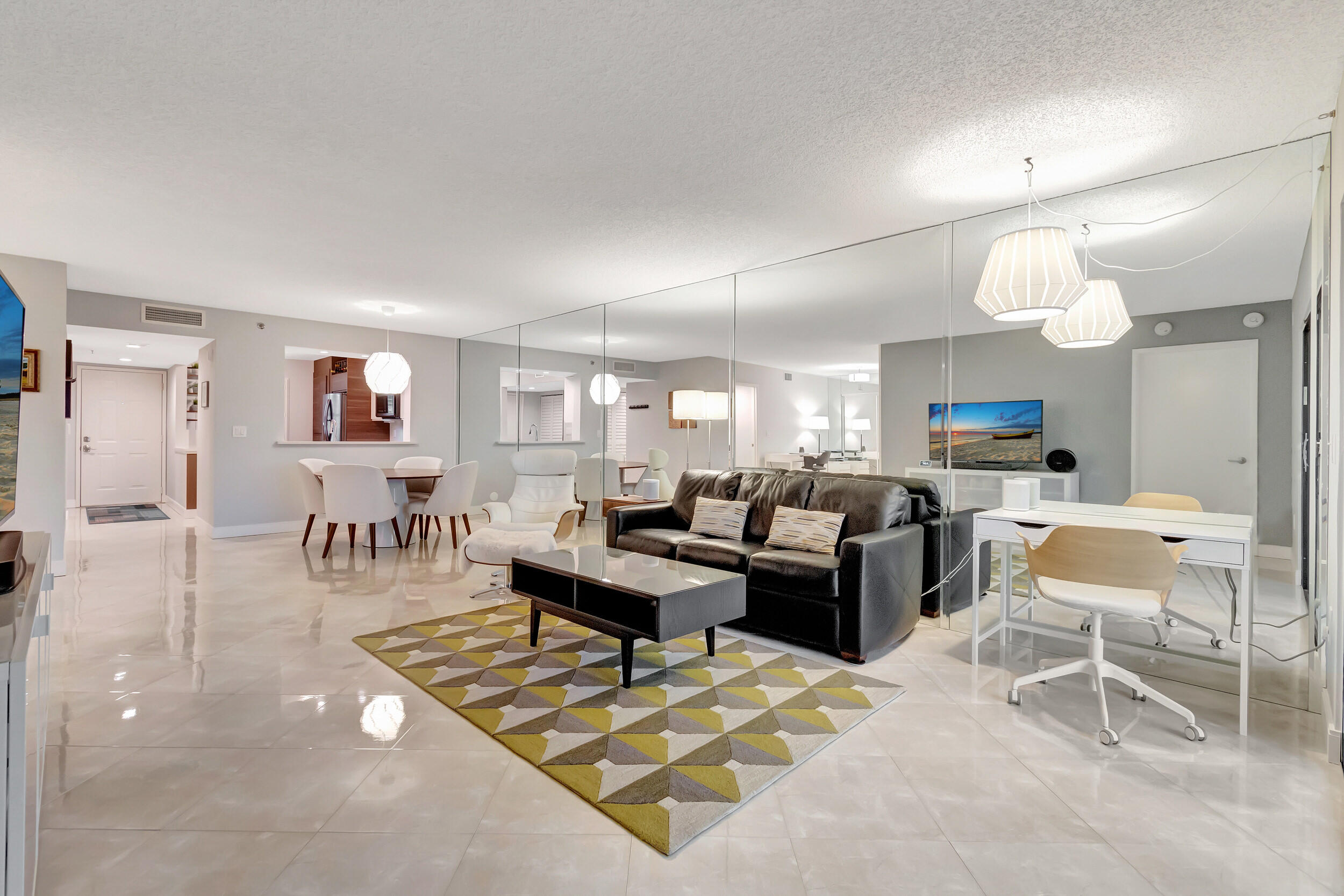 6269 Pointe Regal Circle, Unit 102 Delray Beach, FL 33484 - Photo 16 of 51 a living room with lots of furniture and a table