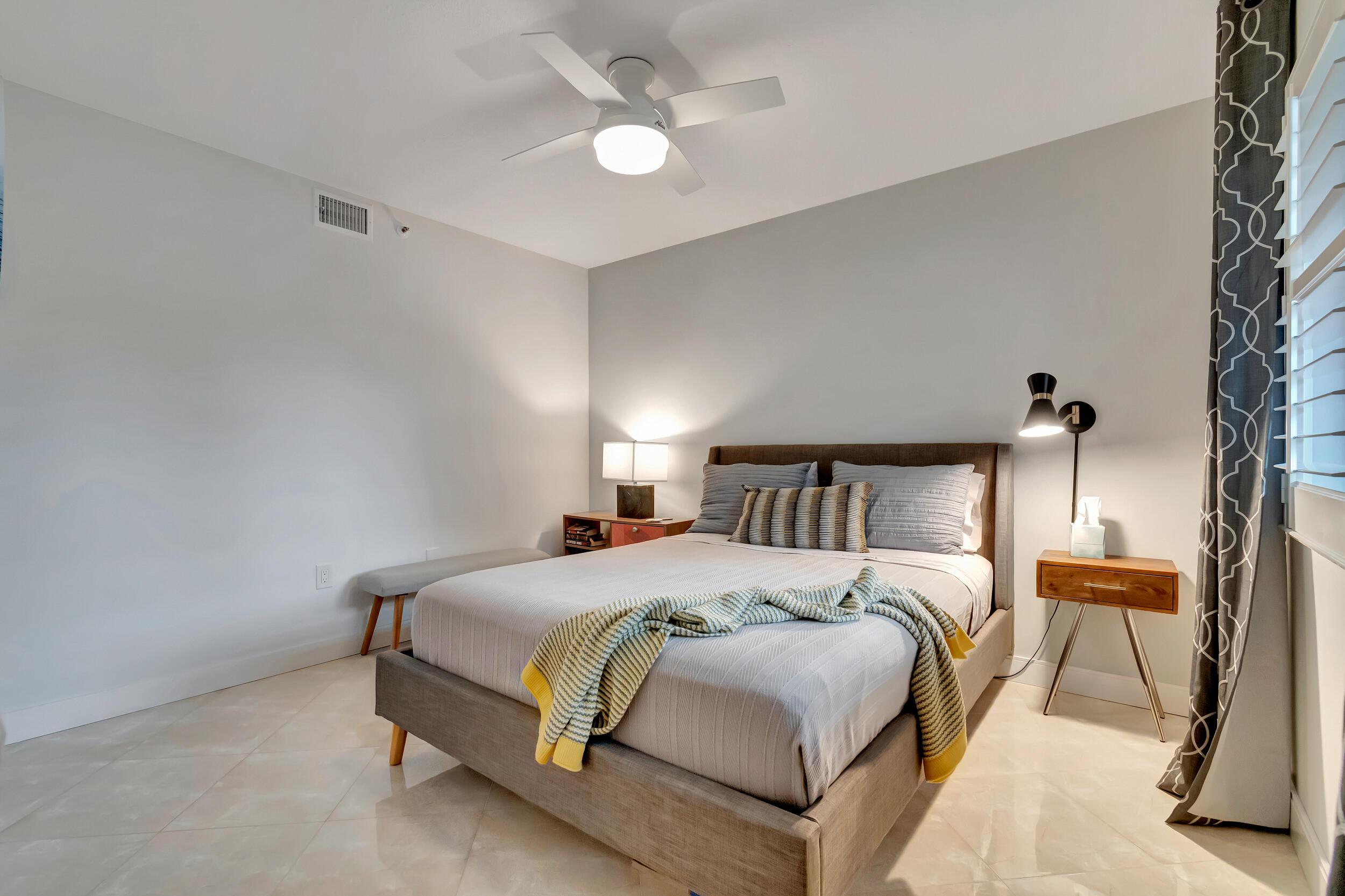 6269 Pointe Regal Circle, Unit 102 Delray Beach, FL 33484 - Photo 28 of 51 a bedroom with a bed and a chandelier