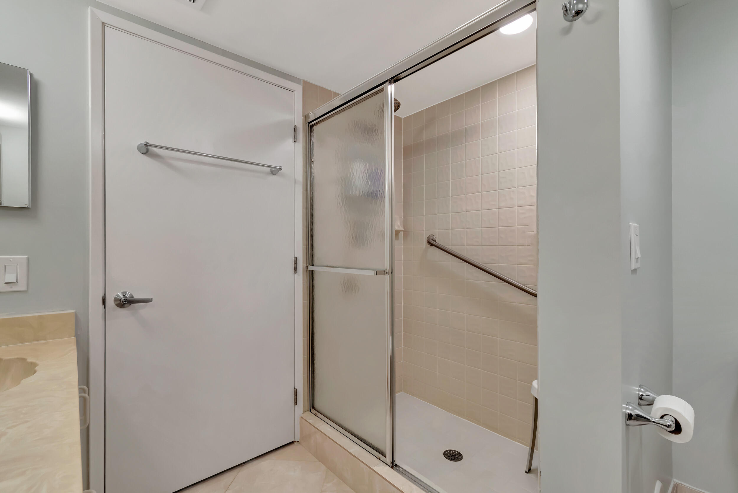 6269 Pointe Regal Circle, Unit 102 Delray Beach, FL 33484 - Photo 29 of 51 a bathroom with a glass shower door