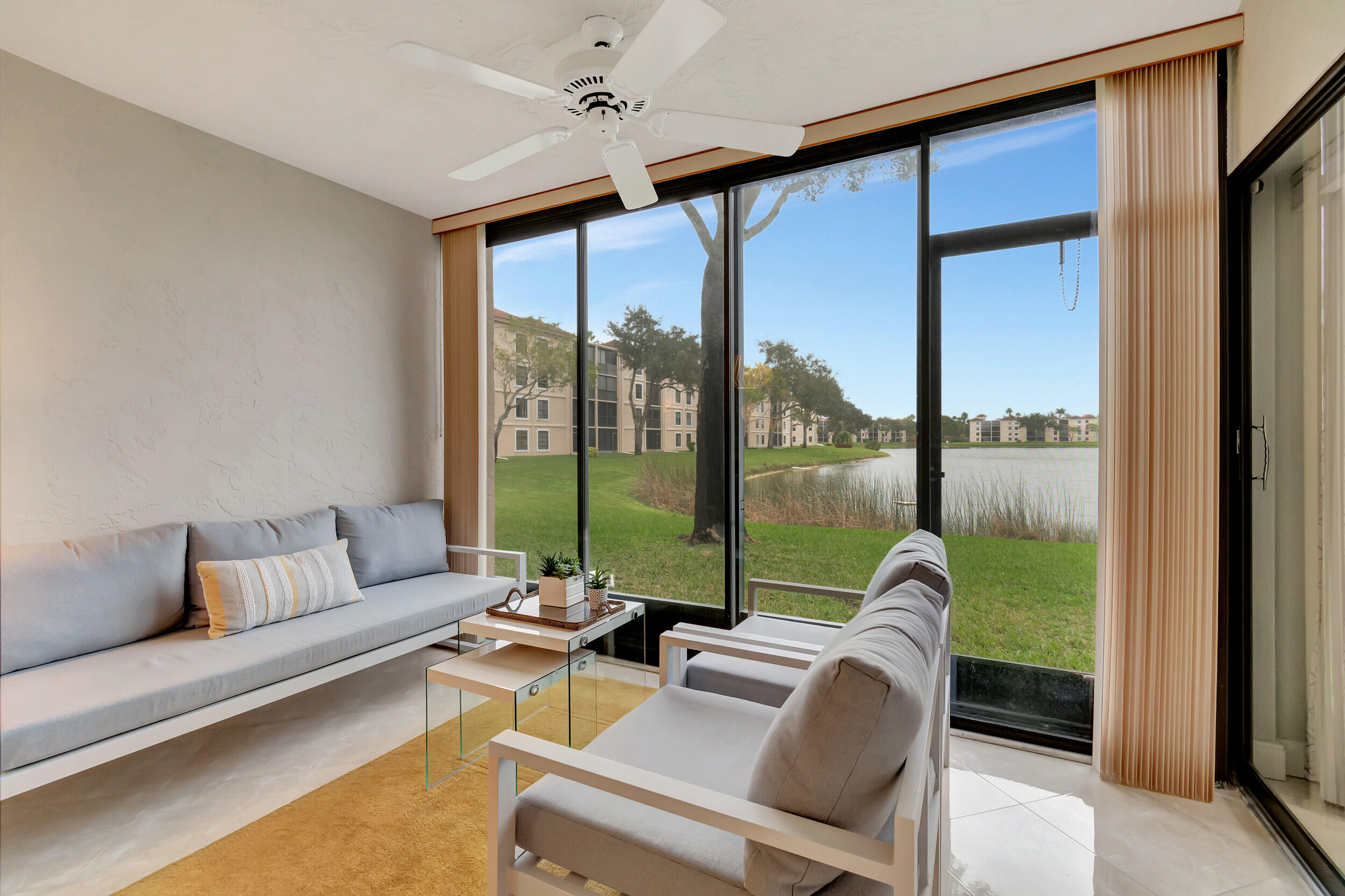 6269 Pointe Regal Circle, Unit 102 Delray Beach, FL 33484 - Photo 31 of 51 a living room with furniture and a large window