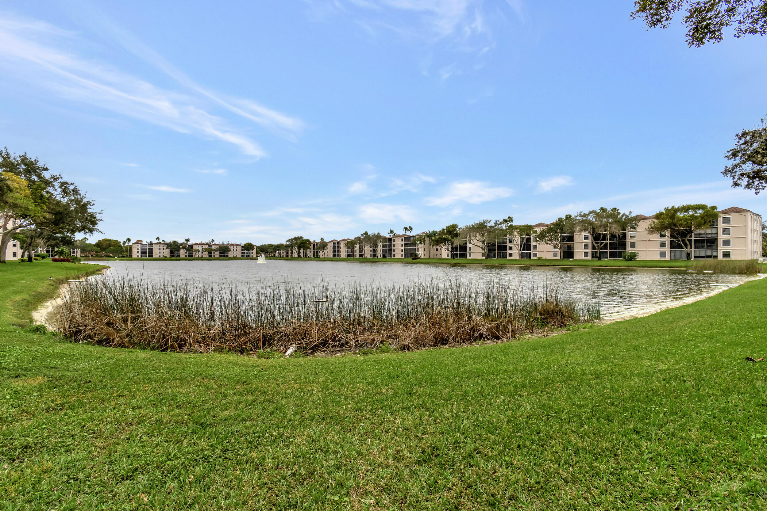 6269 Pointe Regal Circle, Unit 102 Delray Beach, FL 33484 - Photo 34 of 51 a view of a lake with houses in the back