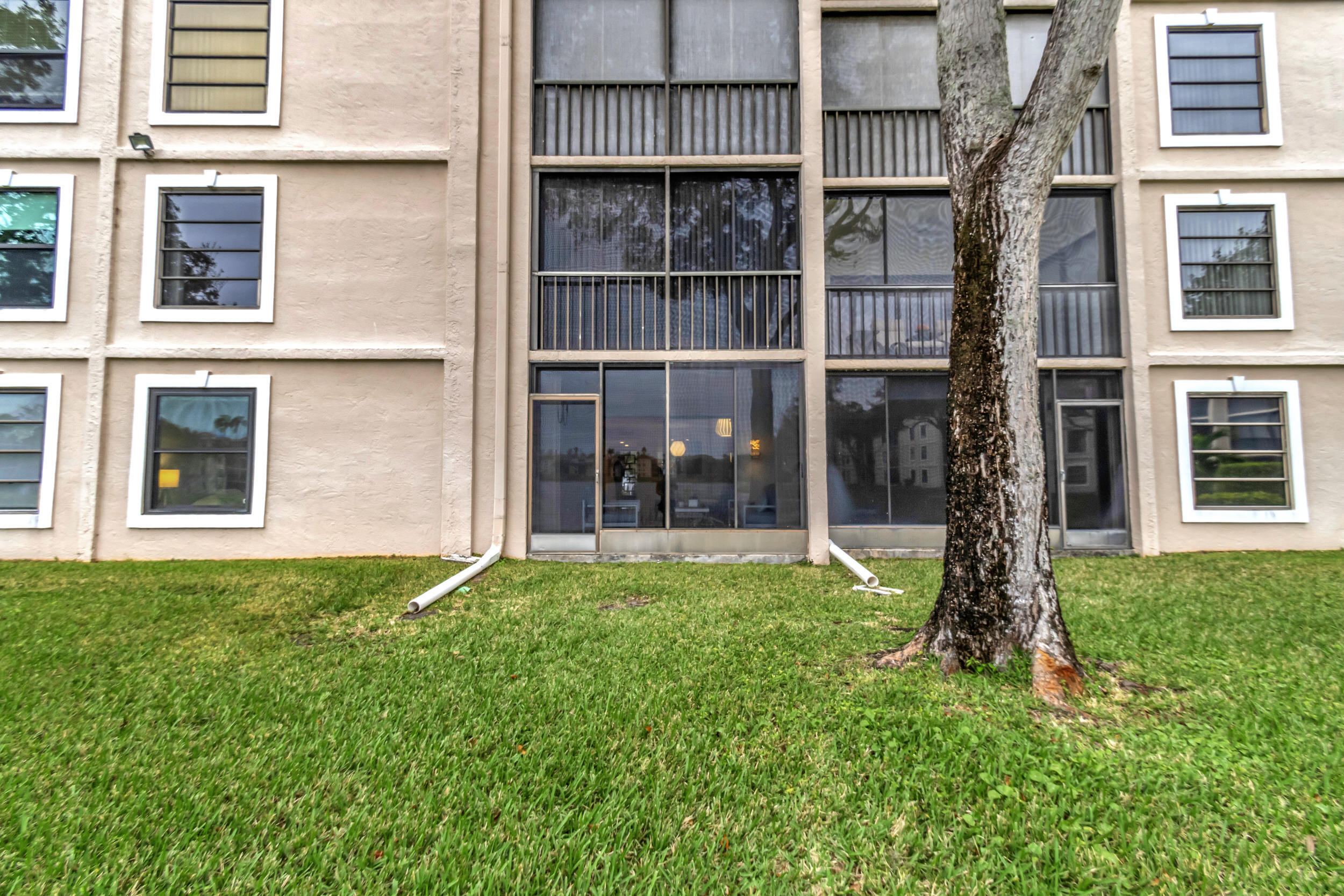 6269 Pointe Regal Circle, Unit 102 Delray Beach, FL 33484 - Photo 36 of 51 a front view of a house with a garden