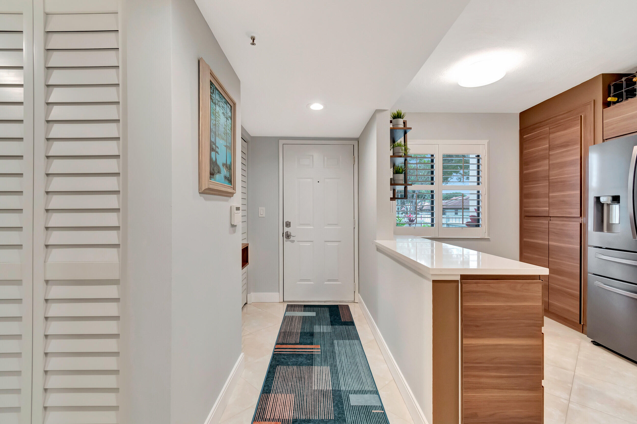 6269 Pointe Regal Circle, Unit 102 Delray Beach, FL 33484 - Photo 4 of 51 a bathroom with a sink and a mirror