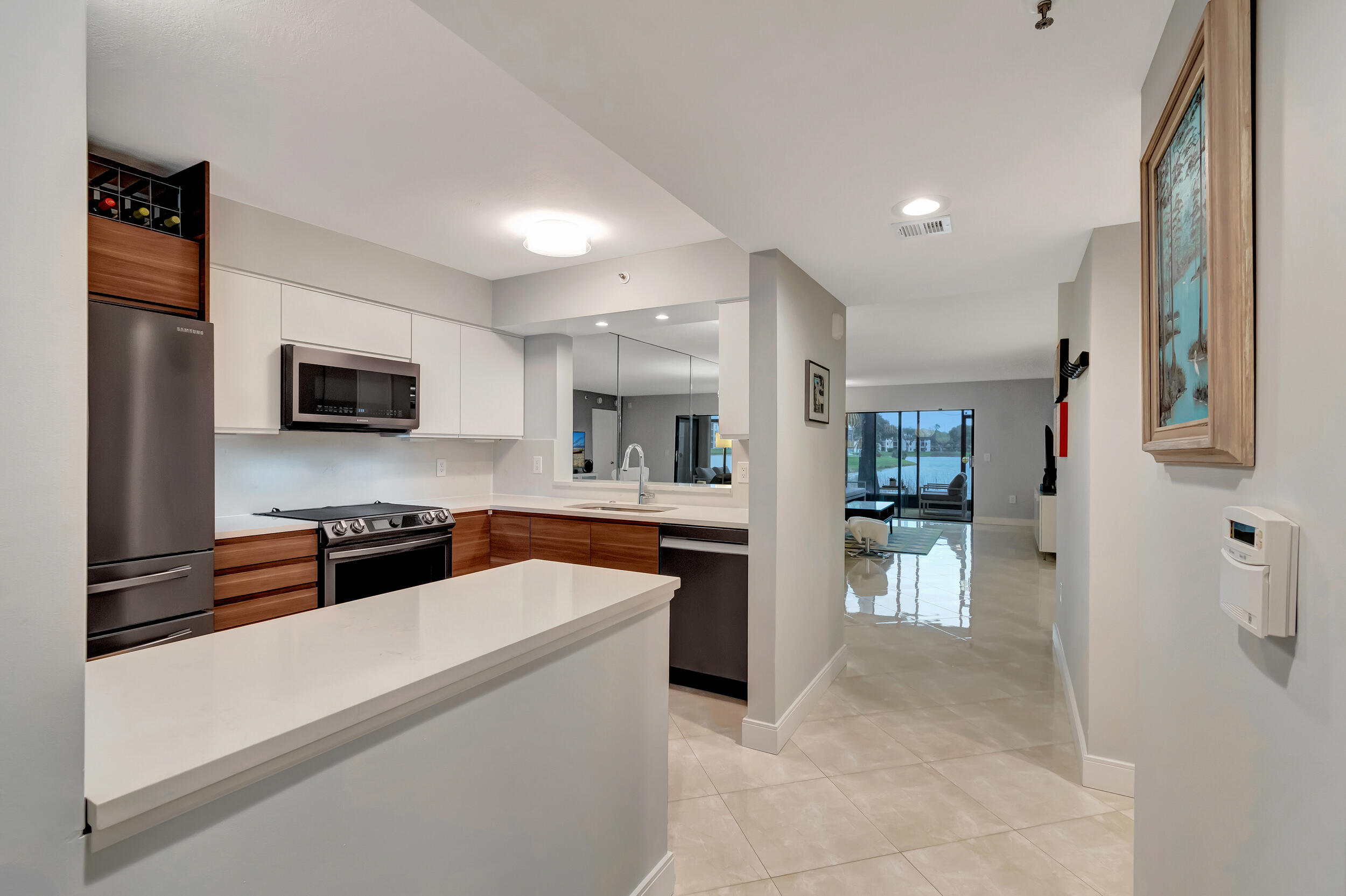 6269 Pointe Regal Circle, Unit 102 Delray Beach, FL 33484 - Photo 5 of 51 a large white kitchen with cabinets