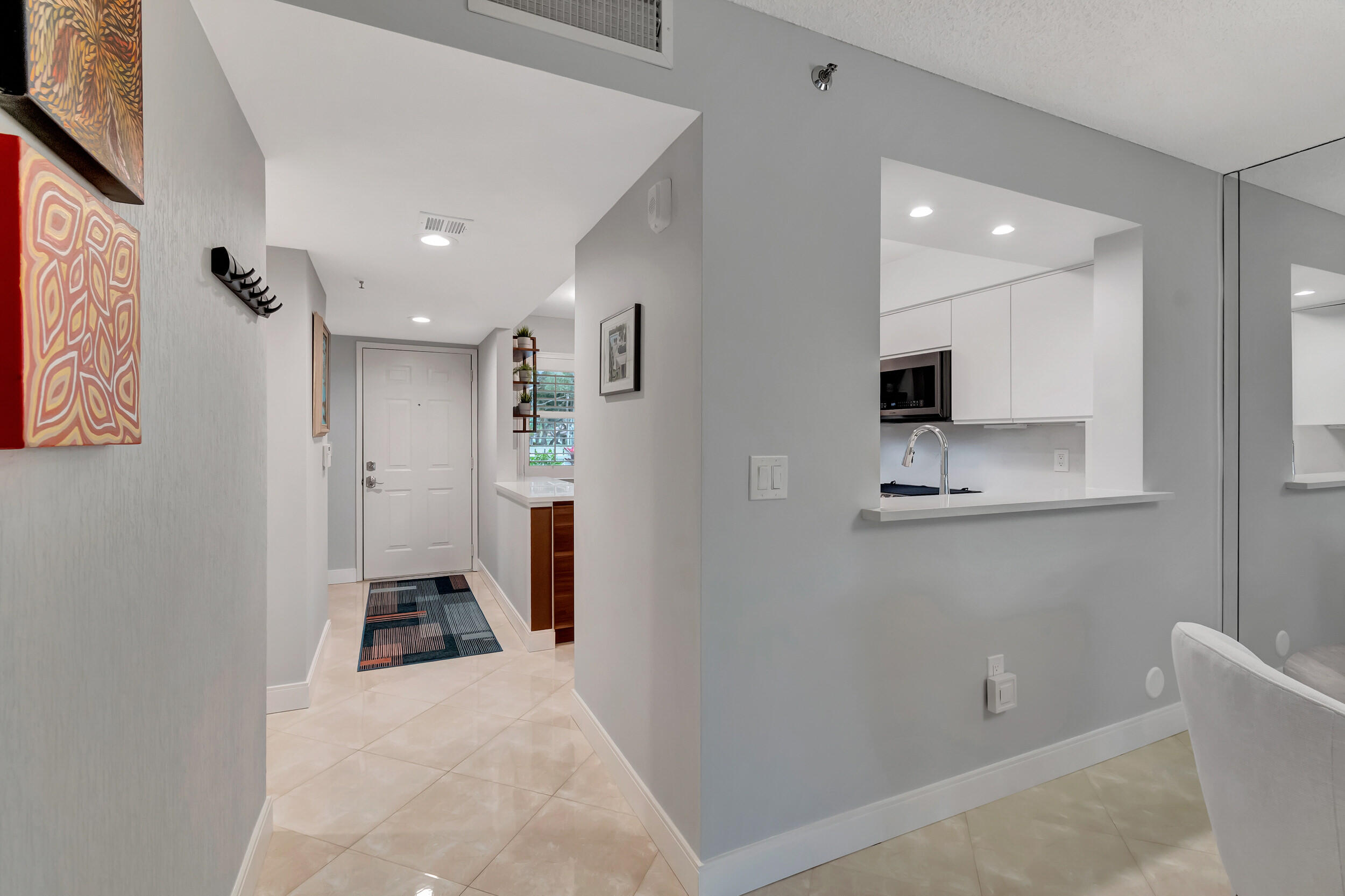 6269 Pointe Regal Circle, Unit 102 Delray Beach, FL 33484 - Photo 6 of 51 a bathroom with a sink and mirror