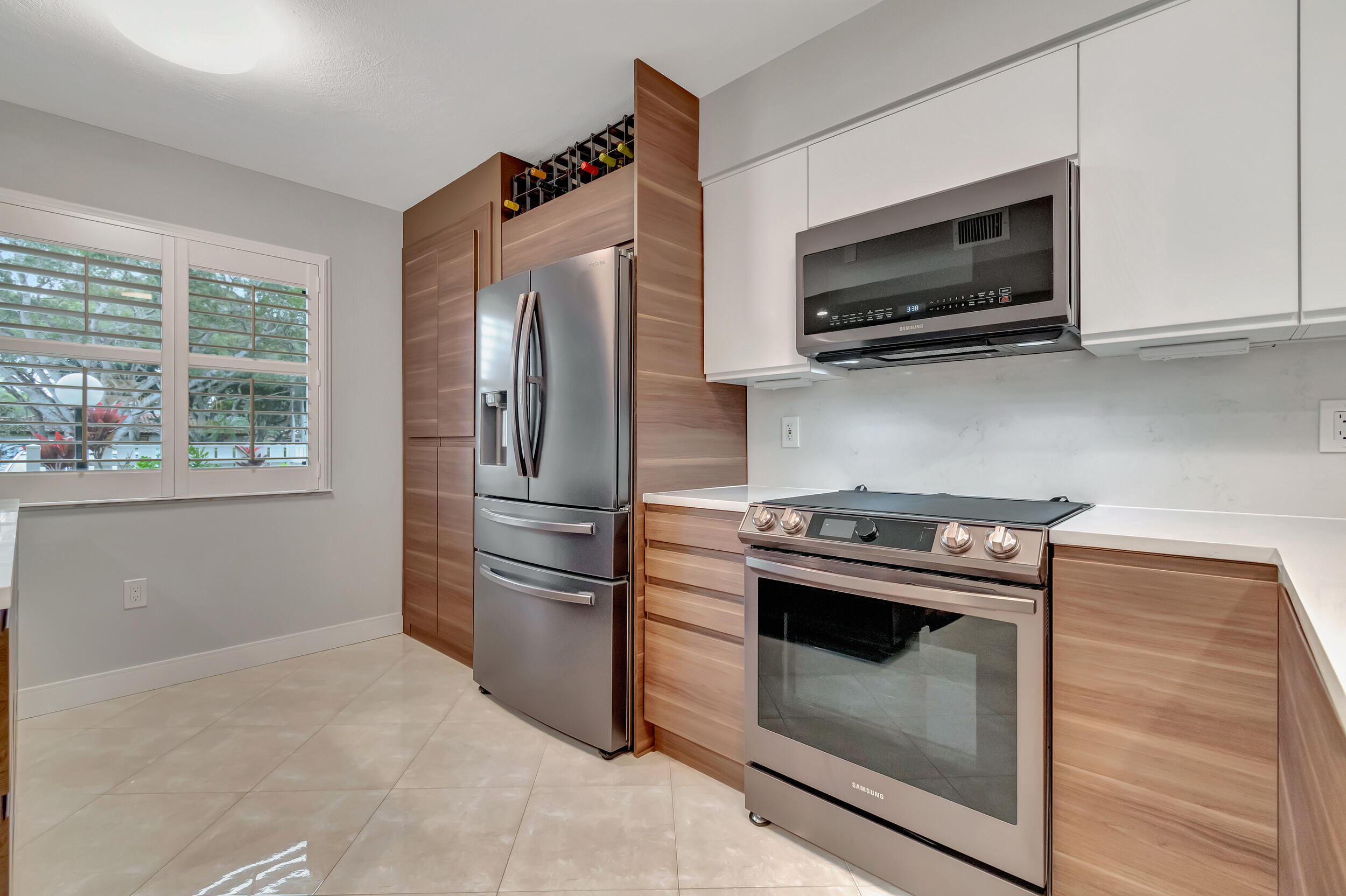 6269 Pointe Regal Circle, Unit 102 Delray Beach, FL 33484 - Photo 8 of 51 a kitchen with a stove microwave and refrigerator