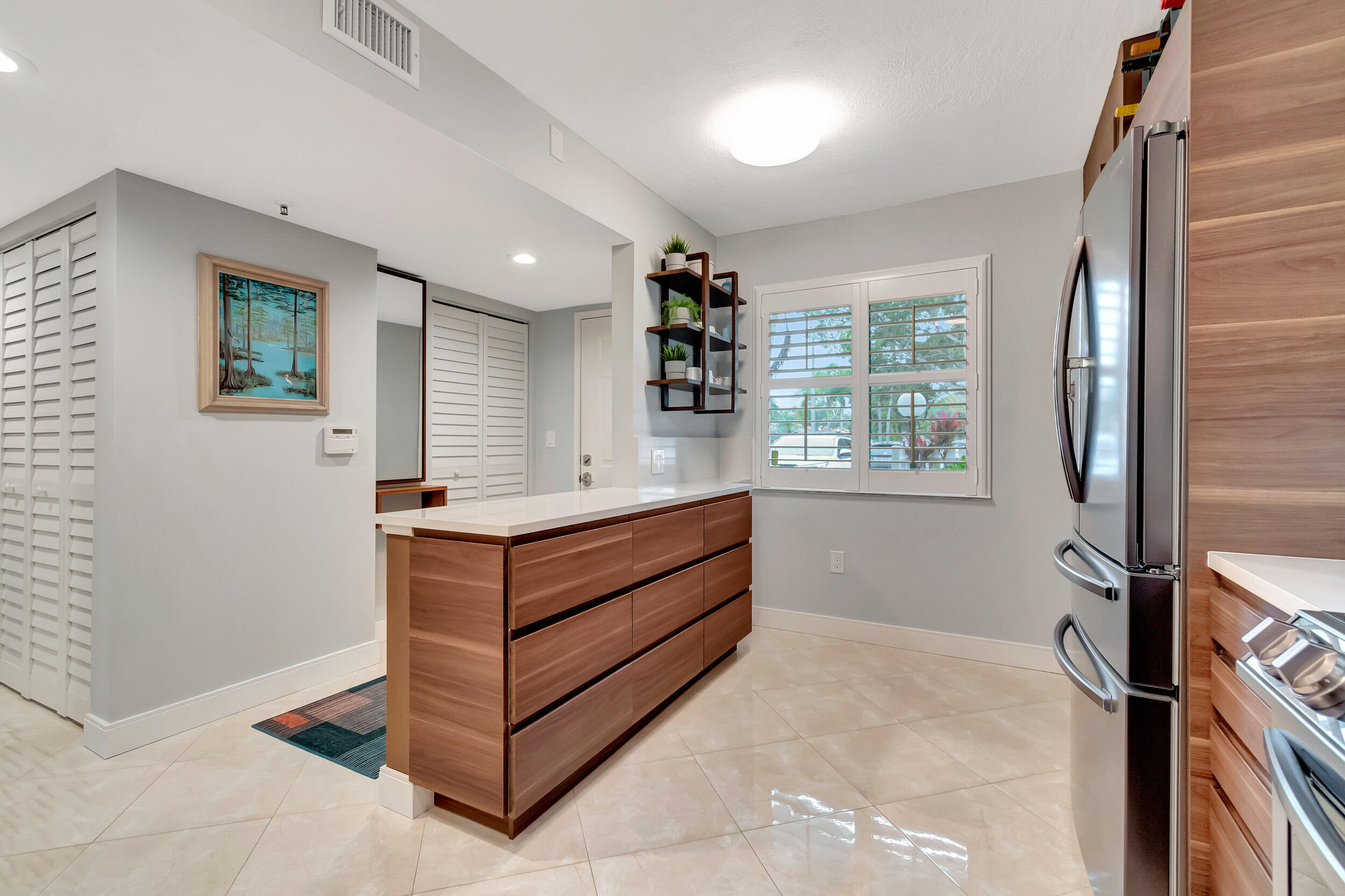 6269 Pointe Regal Circle, Unit 102 Delray Beach, FL 33484 - Photo 9 of 51 a room with furniture and window