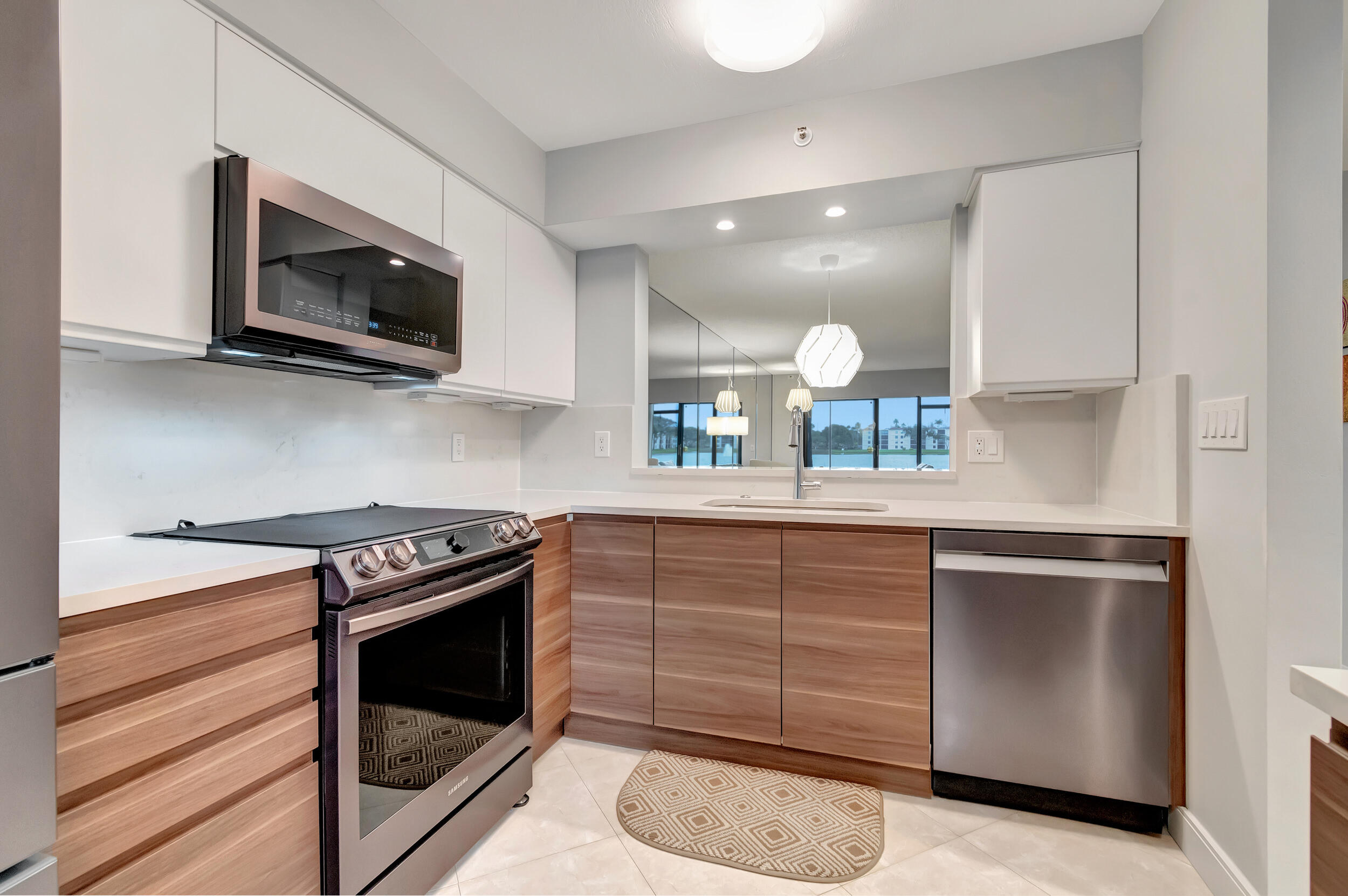 6269 Pointe Regal Circle, Unit 102 Delray Beach, FL 33484 - Photo 10 of 51 a kitchen with a stove and a microwave