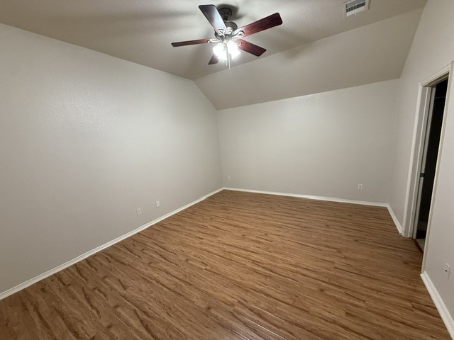20724 Kearney Hill Road Pflugerville, TX 78660 - Photo 25 of 40 Spacious room featuring wood-finish flooring, light neutral wall paint, white trim, and a ceiling fan with light fixture