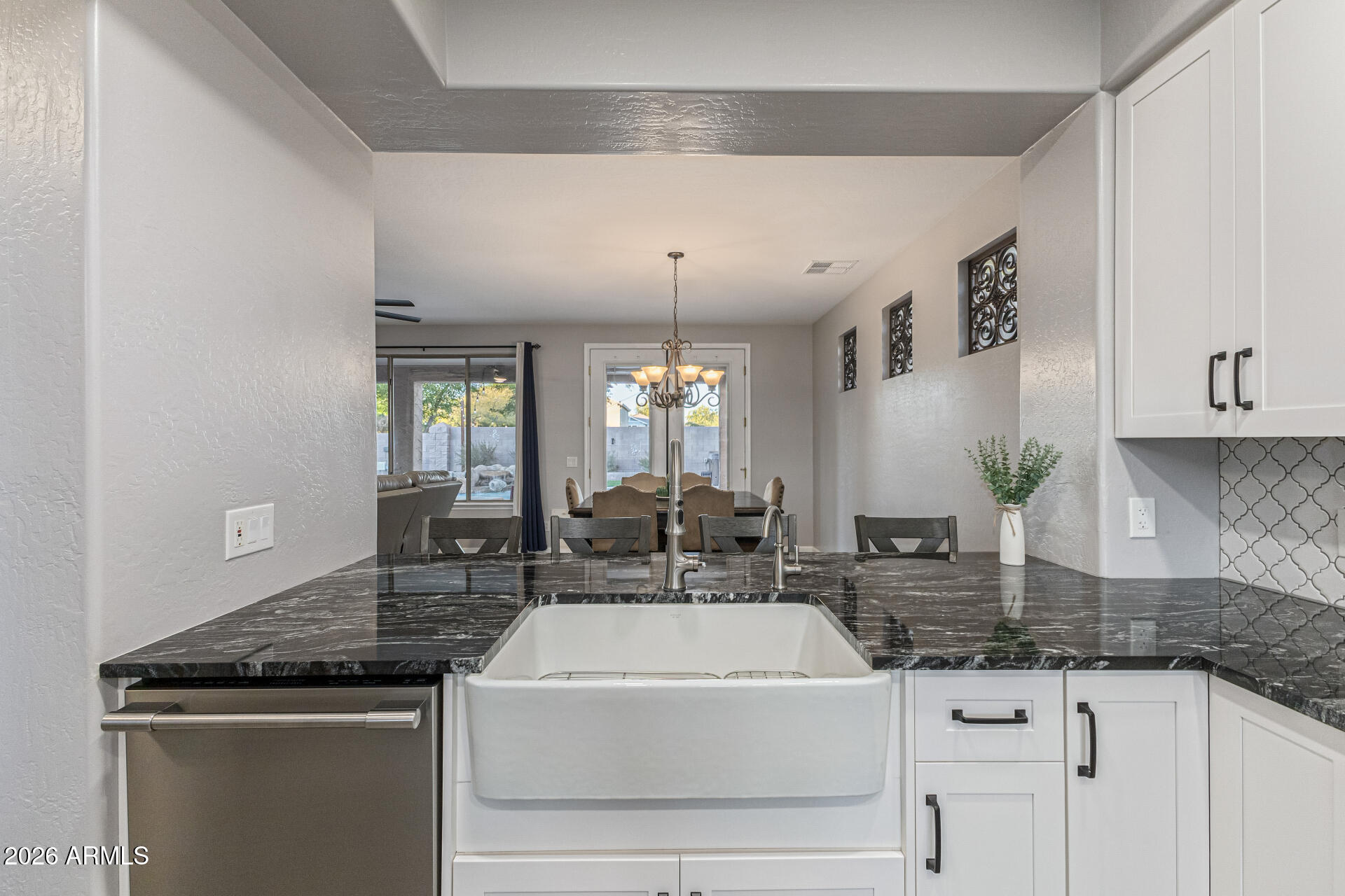 2500 East Milky Way Gilbert, AZ 85295 - Photo 13 of 33 a kitchen with granite countertop a sink a stove and cabinets