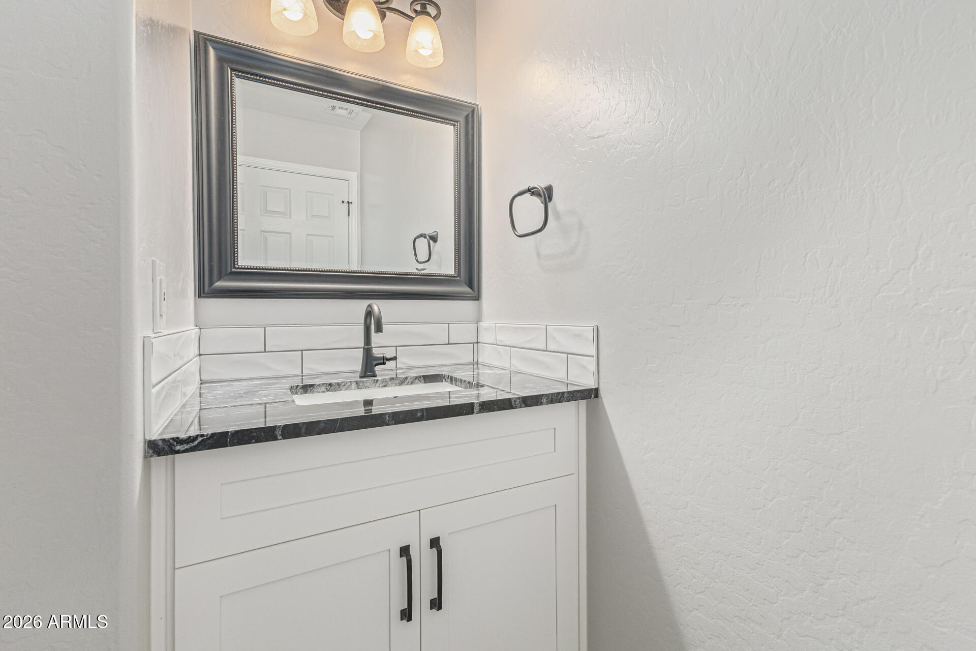 2500 East Milky Way Gilbert, AZ 85295 - Photo 16 of 33 a bathroom with a granite countertop sink and a mirror